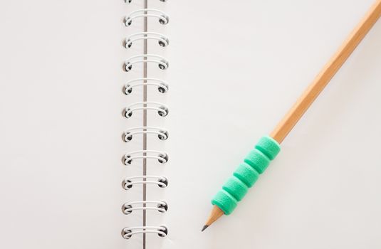 Pencil on open blank notebook, stock photo