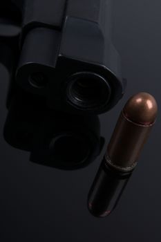 Bbullet and gun on black background