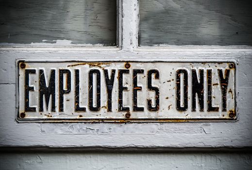 An Employees Only Sign On A Rustic Wooden Door