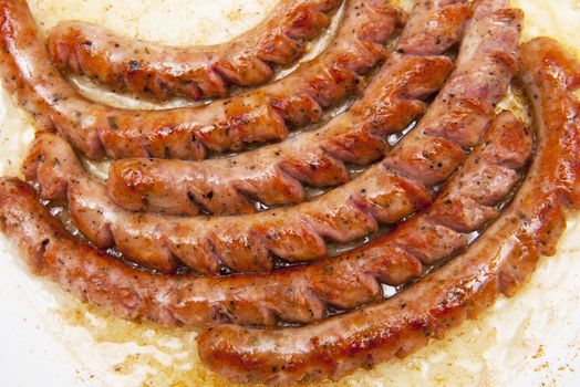 Sausages friyng in the frying pan