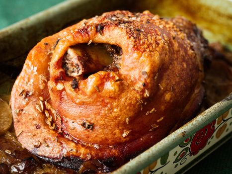 close up of roast golden crispy german pork knuckle