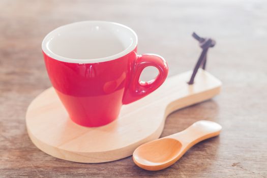 Red mug with wooden plate, stock photo
