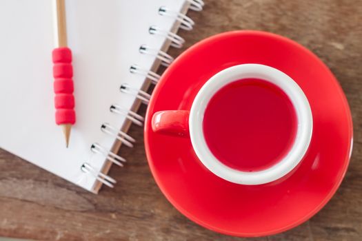Red mug with open notebook, stock photo