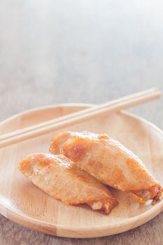 Grilled chicken wings on wooden plate, stock photo