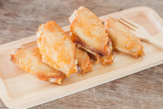 Grilled chicken wings on wooden plate, stock photo