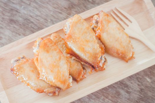 Grilled chicken wings on wooden plate, stock photo