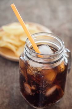 Iced cola with potato chips, stock photo