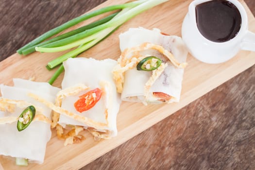 Fresh spring rolls on wooden table, stock photo