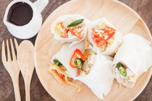 Fresh spring rolls on wooden table, stock photo