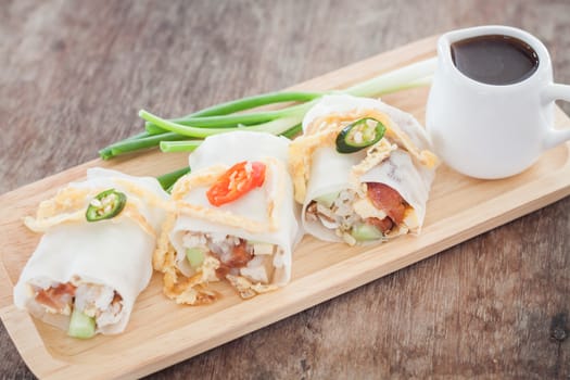 Fresh spring rolls on wooden table, stock photo
