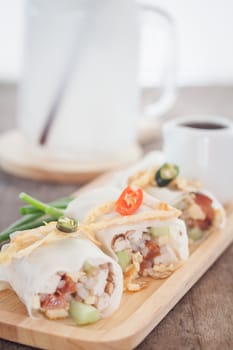 Fresh spring rolls on wooden table, stock photo