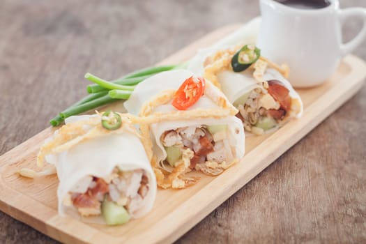 Fresh spring rolls on wooden table, stock photo