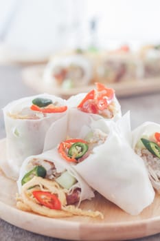 Fresh spring rolls on wooden table, stock photo