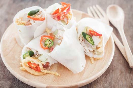 Fresh spring rolls on wooden table, stock photo