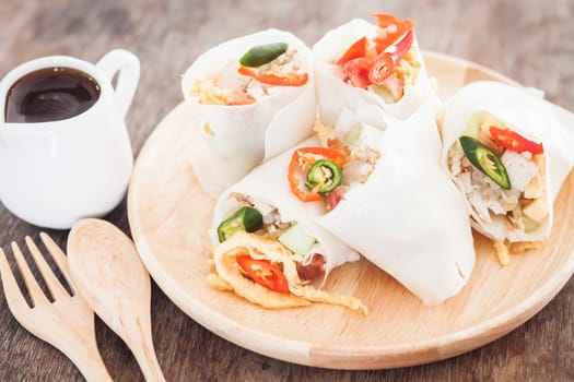 Fresh spring rolls on wooden table, stock photo