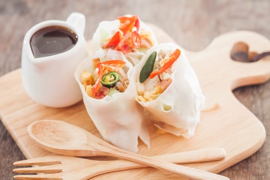 Fresh spring rolls on wooden table, stock photo