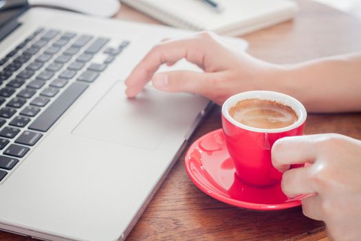 Red coffee cup with notepad and laptop, stock photo