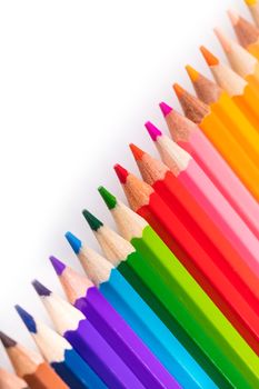 multicolored sharpened pencils close-up on a white background