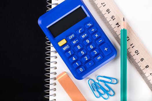 calculator and Office supplies close-up on a black background