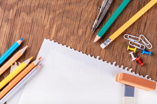 set of stationery items on a wooden background