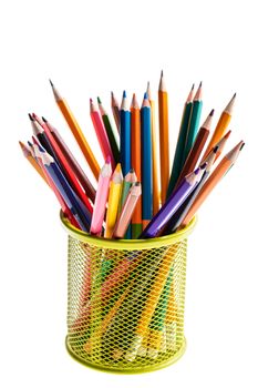 basket with colored pencils on white background