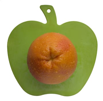orange on apple shape carving board, isolated