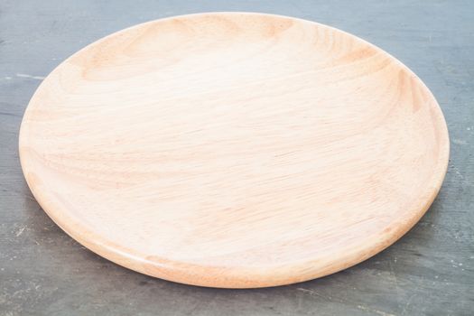 Wooden plate on grey background, stock photo