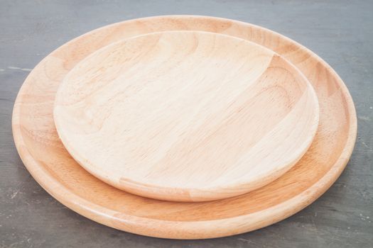 Wooden plate on grey background, stock photo
