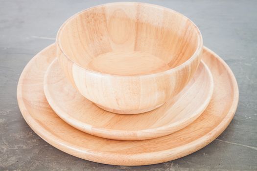 Wooden plate on grey background, stock photo