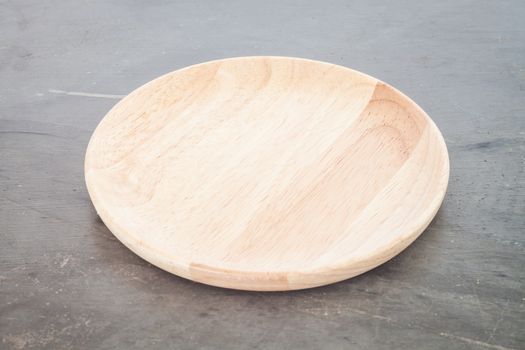 Wooden plate on grey background, stock photo