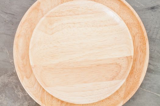 Wooden plate on grey background, stock photo