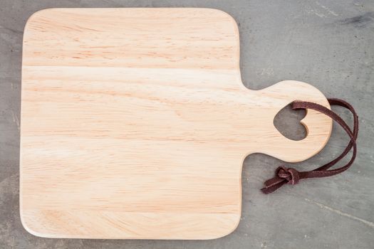 Wooden plate on grey background, stock photo