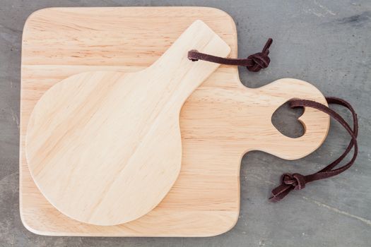 Wooden plate on grey background, stock photo
