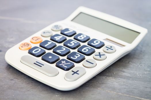 Calculator on grey background, stock photo