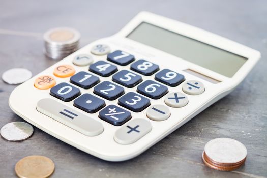 Calculator with money on grey background, stock photo