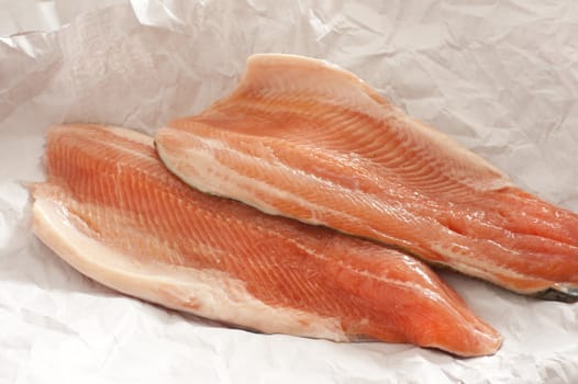 Close up of two fresh pink trout fillets from the fishmongers