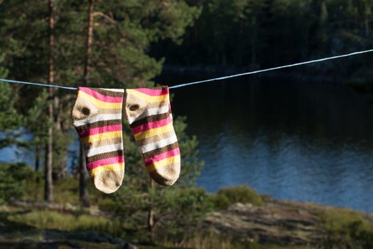 Bright socks drying after washing on the clotheline outdoors