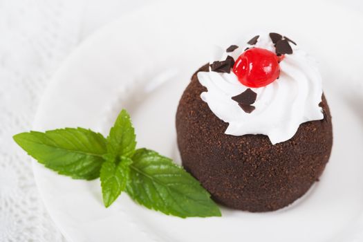 Chocolate sweet cake "Potato" on a plate on table, selective focus