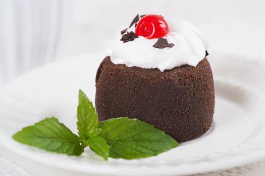 Chocolate sweet cake "Potato" on a plate on table, selective focus