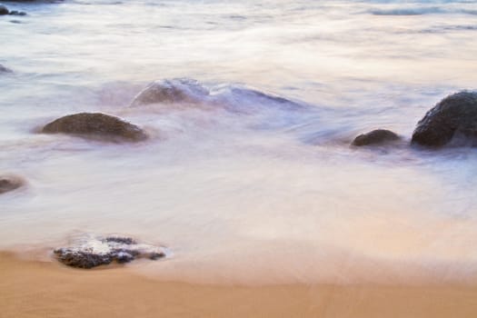  The sea and the rocks at sunset.( blur)