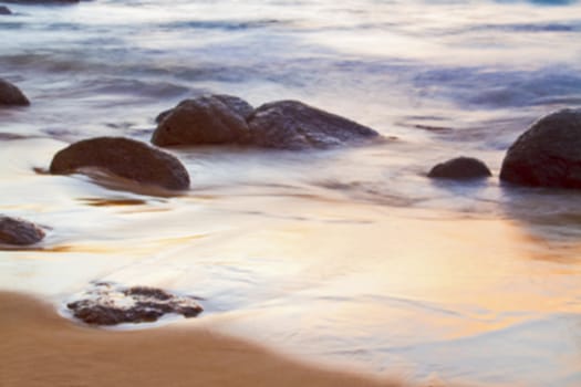 The sea and the rocks at sunset.( blur)