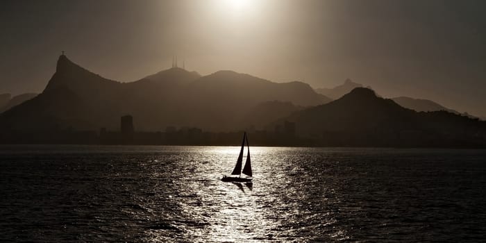 Sailing boat backlit in Rio de Janeiro viewed from the sea