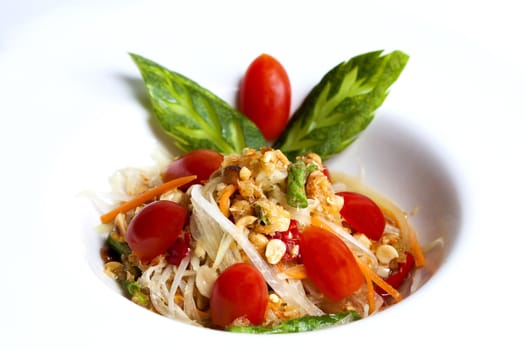 som tum thai served in white plate,Thai papaya spicy salad or know as Som Tum.