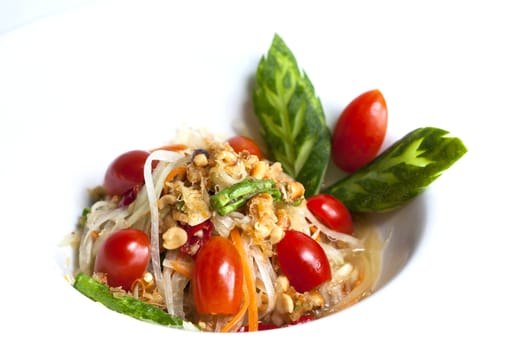som tum thai served in white plate,Thai papaya spicy salad or know as Som Tum.