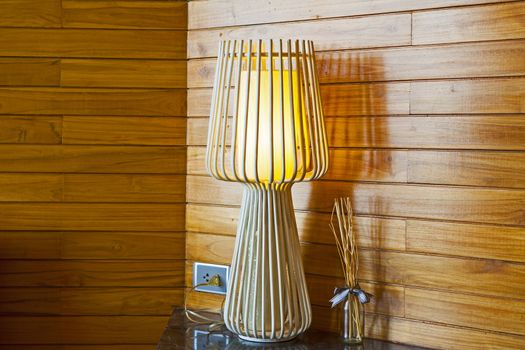 The interior of a bedroom with a lamp.