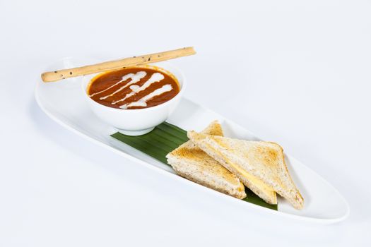Tomato soup with two slices of bread for breakfast.Thai food in a luxury hotel.