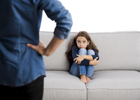 Grown up rebuking a little child for bad behavior