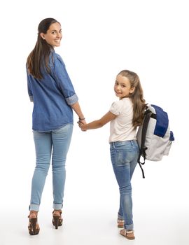 Mother and her little daughter walking together going to the school