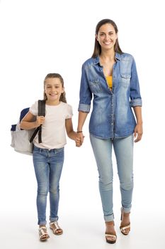 Mother and her little daughter walking together going to the school