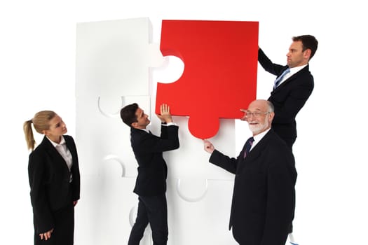 Business people solving problems assembling puzzle isolated on white background
